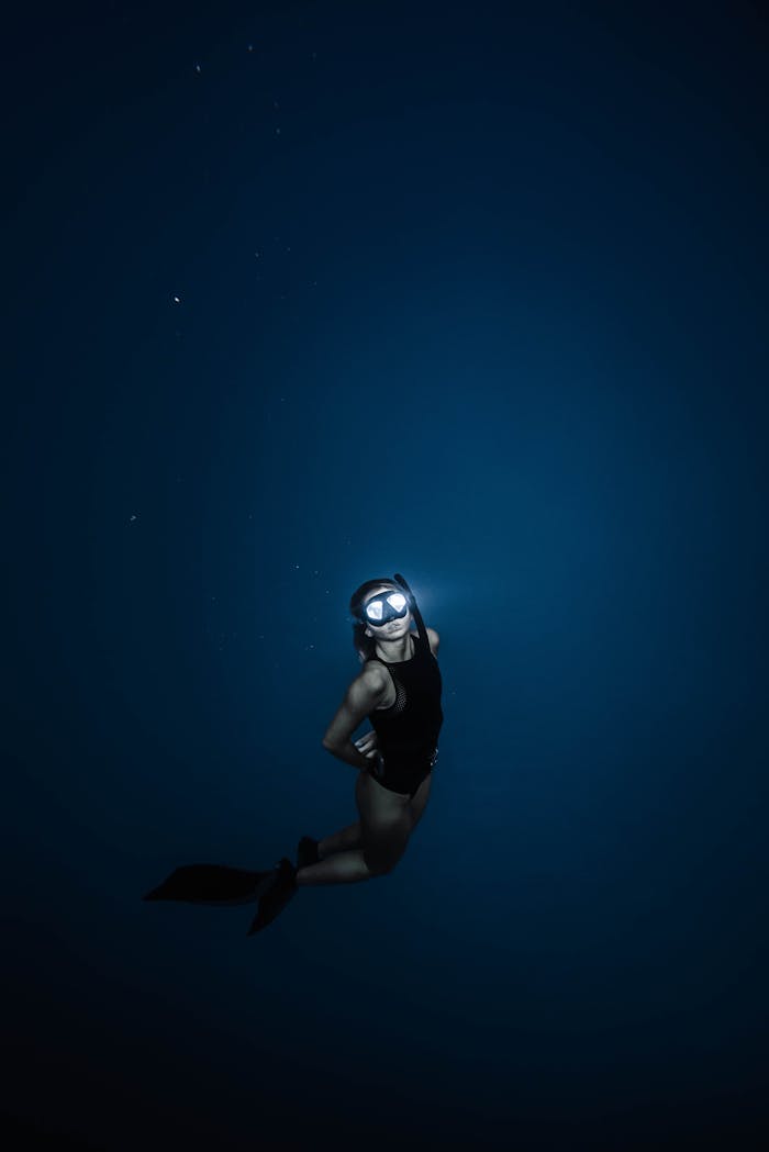A young woman enjoying deep-sea diving, showcasing underwater adventure and marine exploration.